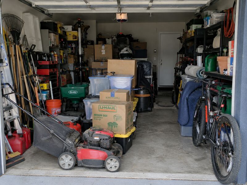 A garage crowded with tools, boxes and equipment