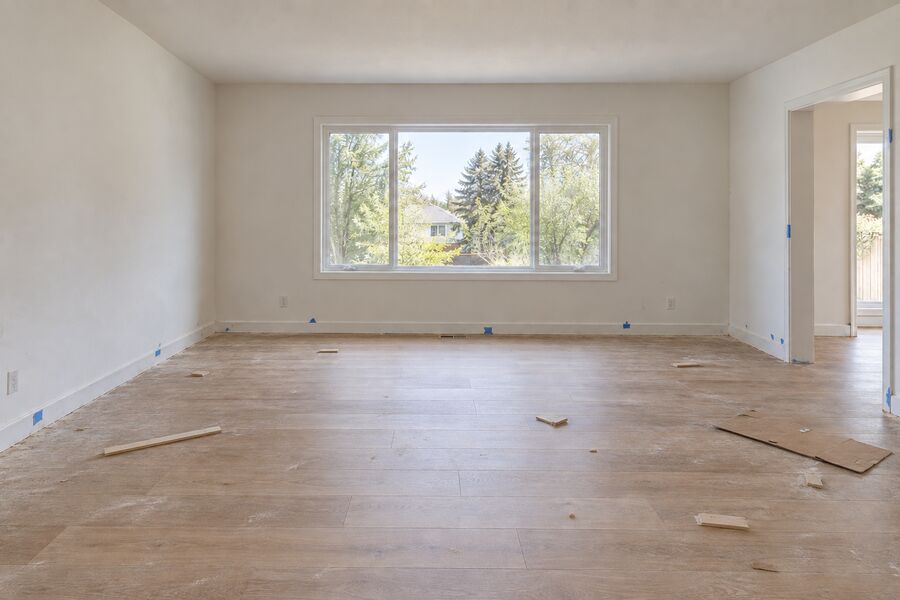 A newly built home interior covered in construction dust and offcuts